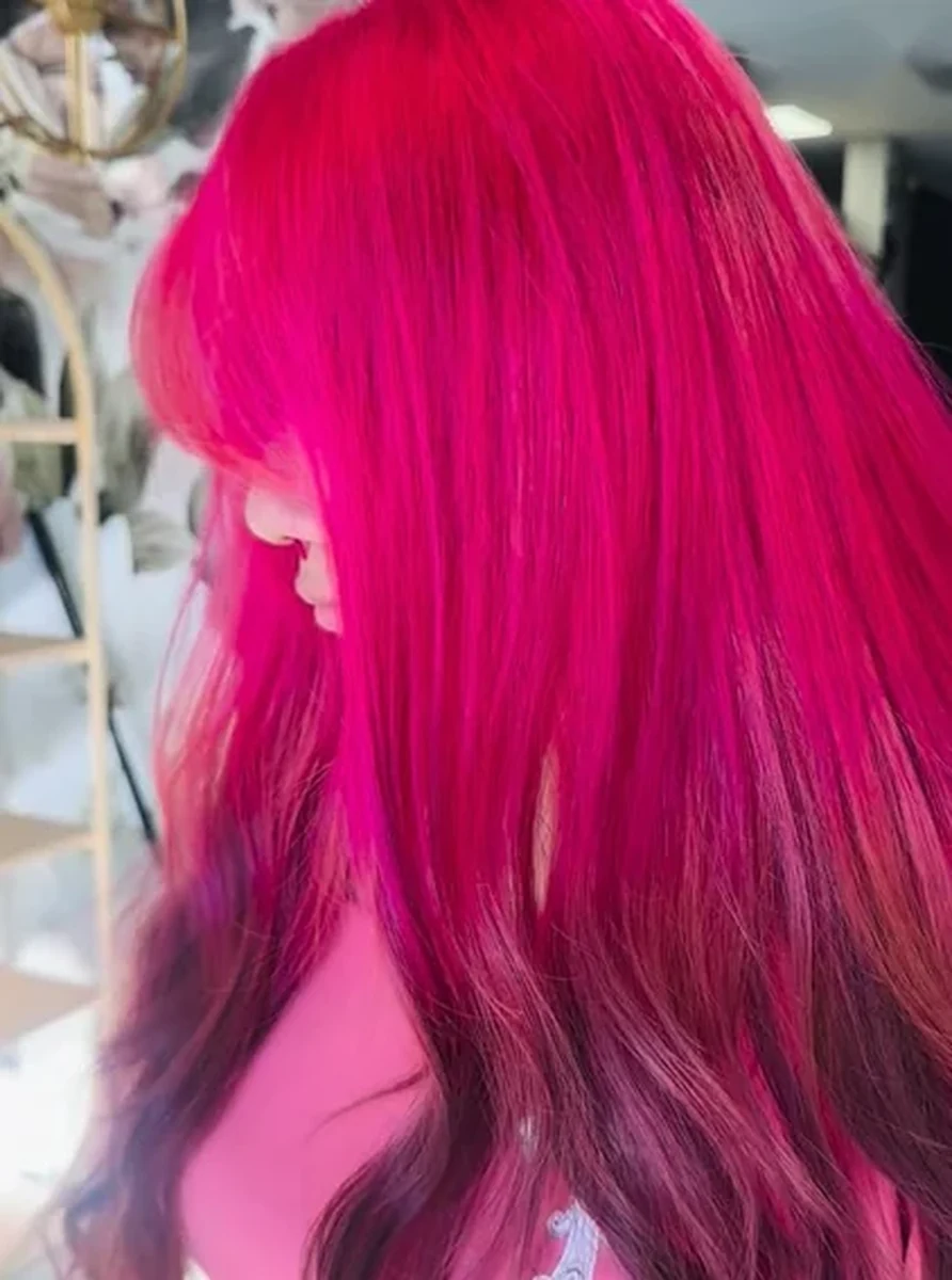 Vivid pink hair color with long smooth layers by Jenn Rose